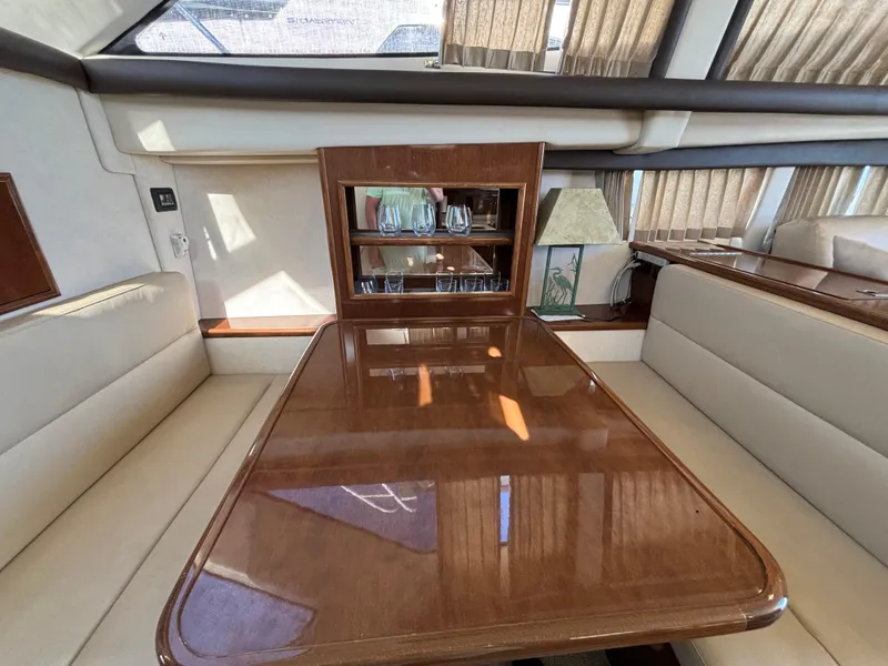 Slide: The Image of Interior of 2008 Carver 360 Sport Sedan with polished wood table and glass cabinet. - 41