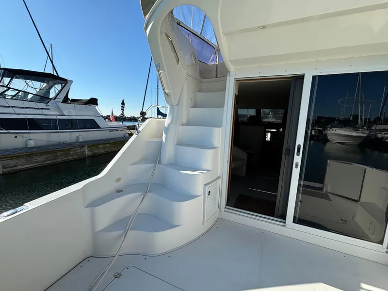 Slide: The Image of 2008 Carver 360 Sport Sedan yacht with stairs and sliding door, docked at marina. - 8
