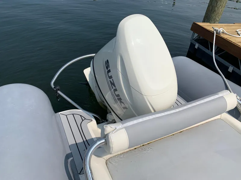 Slide: The Image of 2019 Inmar 635 boat with Suzuki outboard motor, docked on calm water. - 10