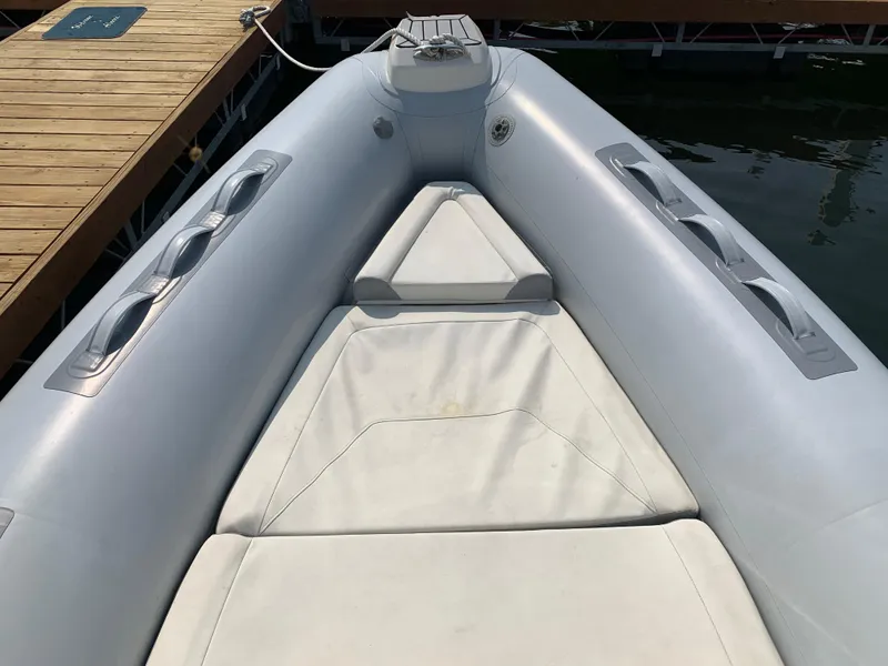 Slide: The Image of 2019 Inmar 635 inflatable boat bow with seating, docked on calm water. - 12