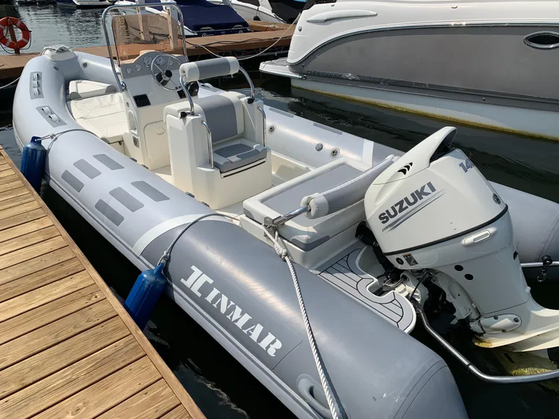 Slide: The Image of 2019 Inmar 635 inflatable boat with Suzuki outboard motor docked at marina. - 6