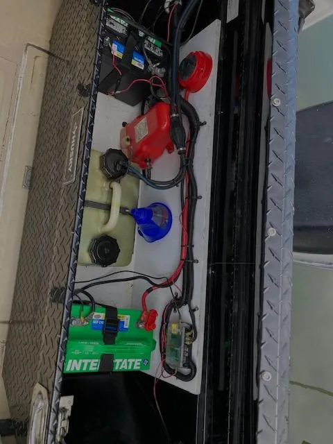 Slide: The Image of 1982 Albemarle 24 boat battery compartment with wiring and components. - 6