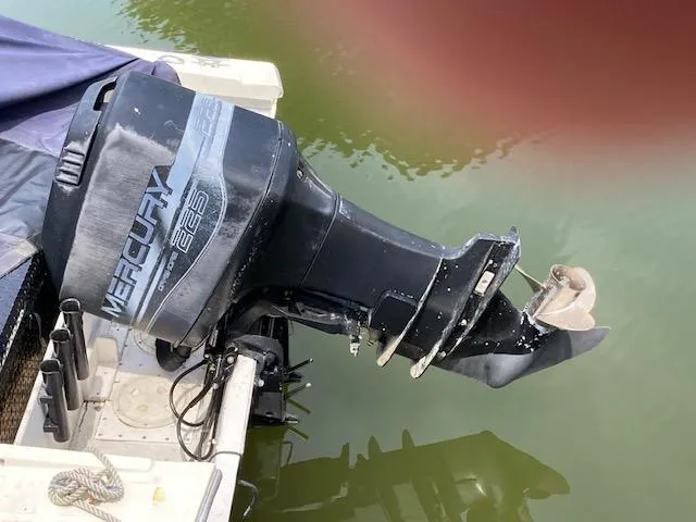 Slide: The Image of Outboard motor on 1982 Albemarle 24 boat, Mercury 225 model, docked on calm water. - 7