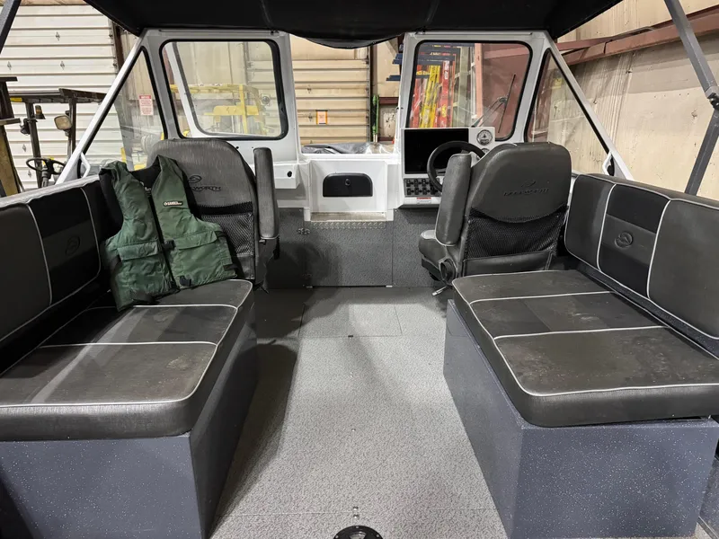Slide: The Image of Interior of a 2022 Duckworth 21 Discovery boat with seating and life jackets. - 6