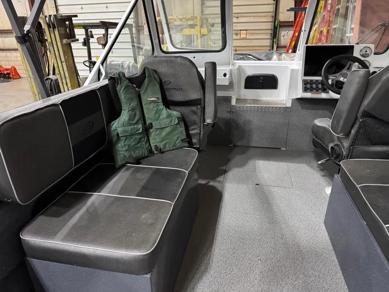 Slide: The Image of Interior of a 2022 Duckworth 21 Discovery boat with seating and life jackets. - 7