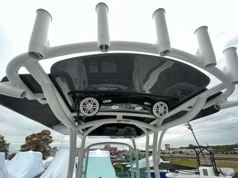 Slide: The Image of 2023 Wellcraft 262 Fisherman boat with rod holders and speakers on the T-top. - 14