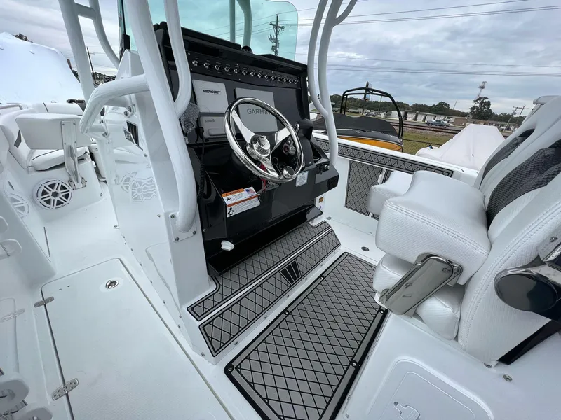 Slide: The Image of 2023 Wellcraft 262 Fisherman boat cockpit with modern steering and seating. - 16