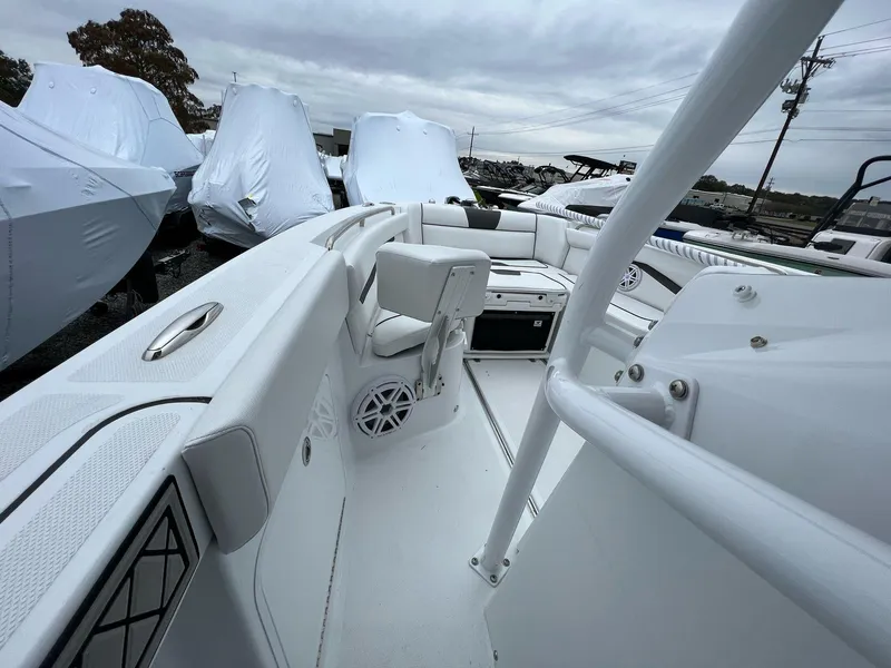 Slide: The Image of 2023 Wellcraft 262 Fisherman boat interior with white seating and storage compartments. - 18