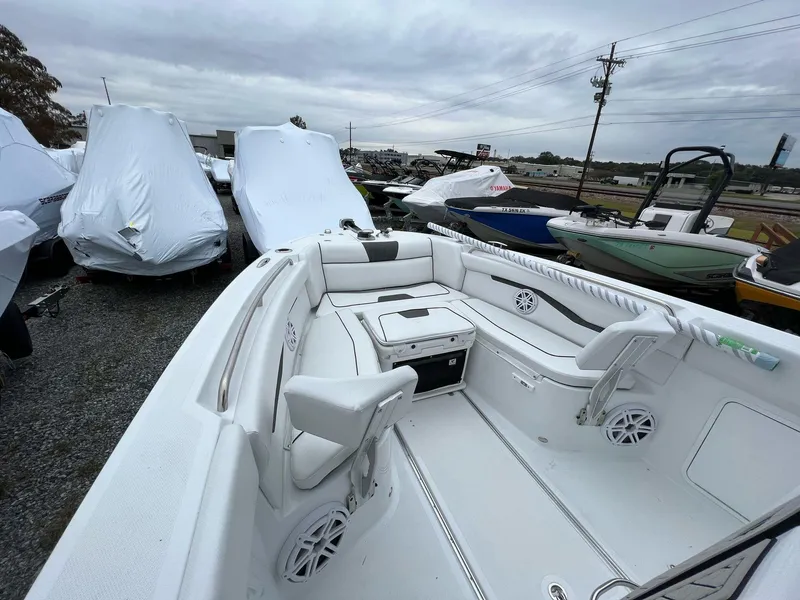 Slide: The Image of 2023 Wellcraft 262 Fisherman boat interior, white seating, parked among covered boats. - 19