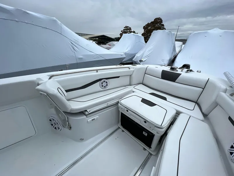 Slide: The Image of 2023 Wellcraft 262 Fisherman boat interior with white seating and storage. - 20