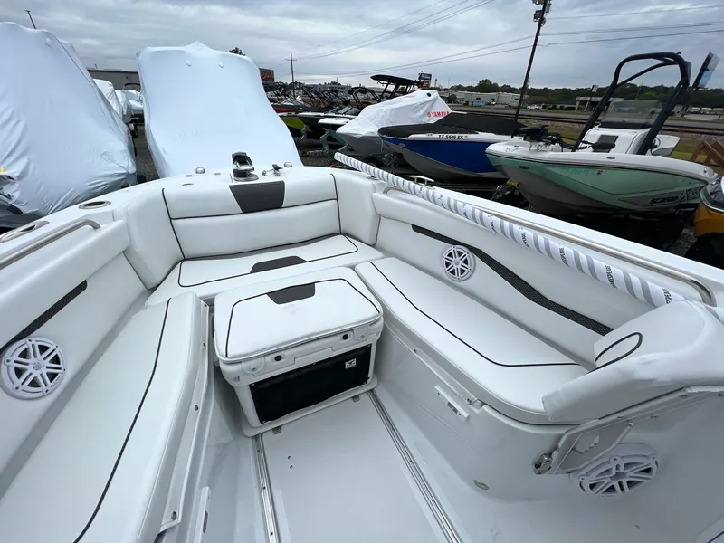 Slide: The Image of 2023 Wellcraft 262 Fisherman boat interior with white seating and speakers. - 21