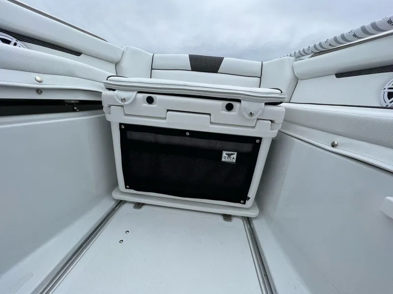 Slide: The Image of Interior view of 2023 Wellcraft 262 Fisherman boat, featuring sleek white seating and storage. - 23