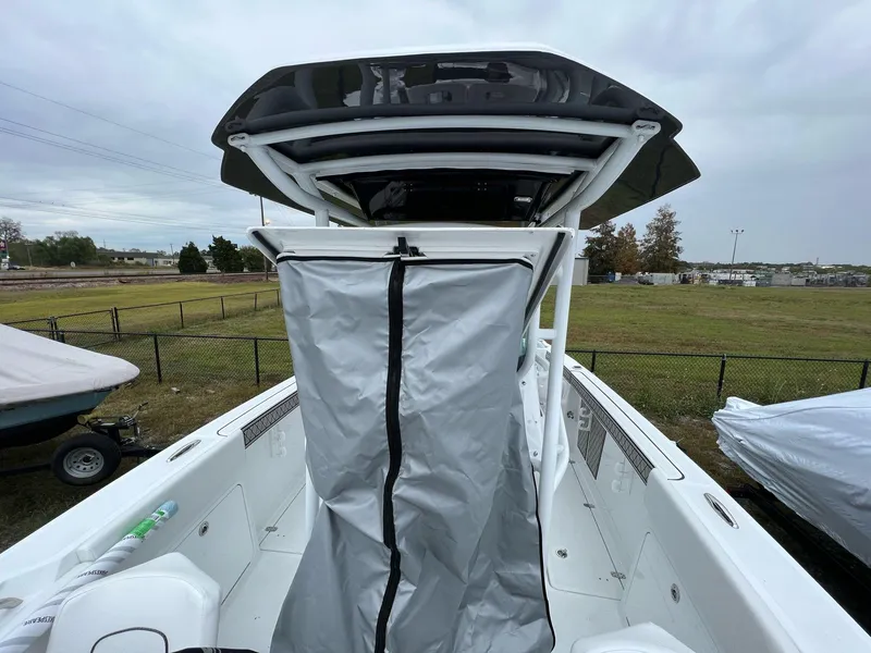 Slide: The Image of 2023 Wellcraft 262 Fisherman boat with covered console, outdoor setting. - 24