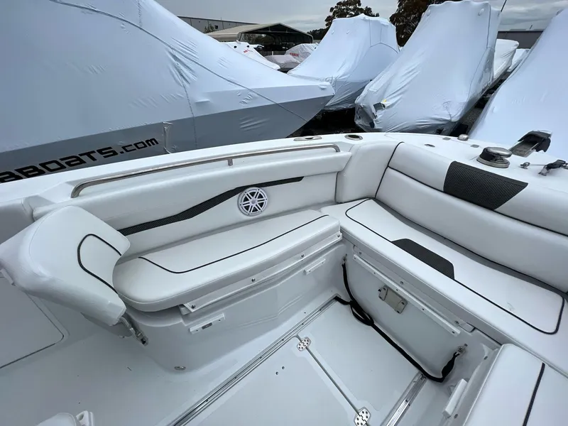 Slide: The Image of 2023 Wellcraft 262 Fisherman boat interior with white seating and storage compartments. - 30