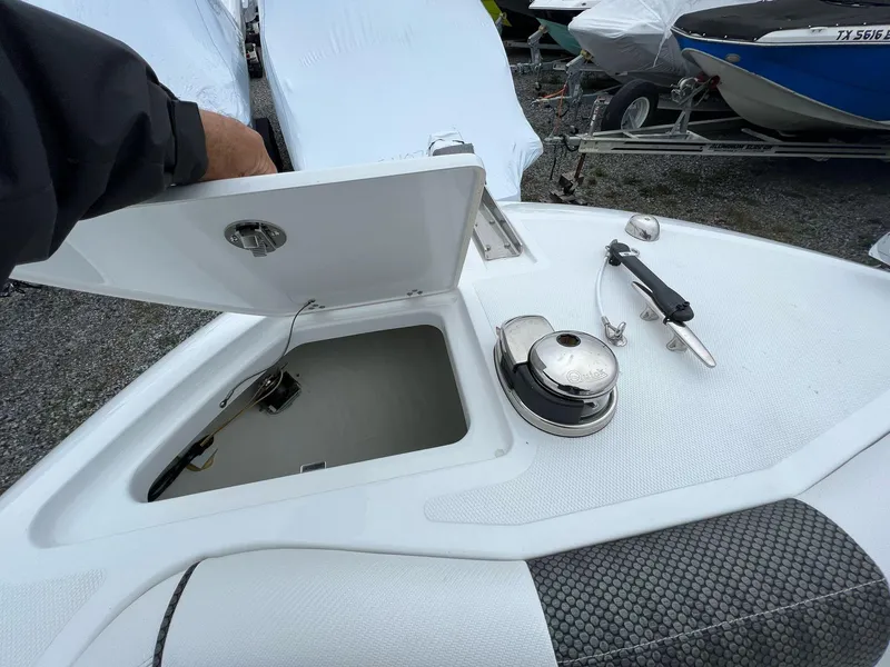 Slide: The Image of 2023 Wellcraft 262 Fisherman boat anchor compartment with open hatch and winch. - 32