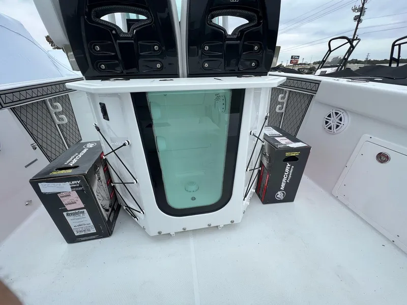 Slide: The Image of 2023 Wellcraft 262 Fisherman boat deck with storage and Mercury propeller boxes. - 38