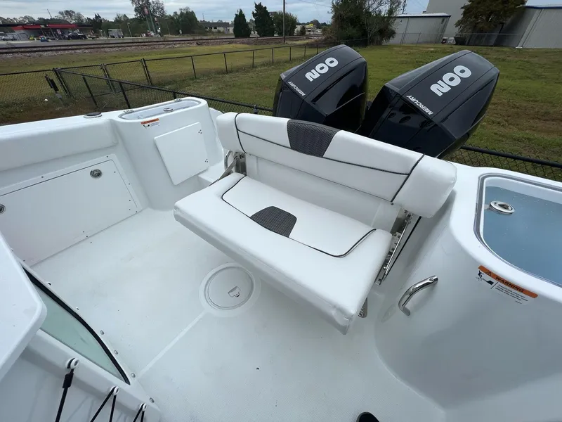 Slide: The Image of 2023 Wellcraft 262 Fisherman boat interior with seating and dual outboard motors. - 39