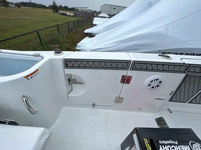 Slide: The Image of 2023 Wellcraft 262 Fisherman boat interior with storage and speaker details. - 42