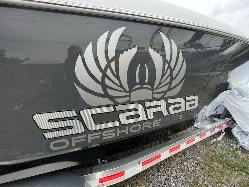 Slide: The Image of 2023 Wellcraft 262 Fisherman boat with Scarab Offshore logo on the side. - 48