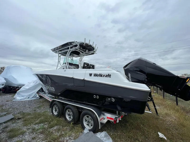 Slide: The Image of 2023 Wellcraft 262 Fisherman boat on trailer, overcast sky background. - 5