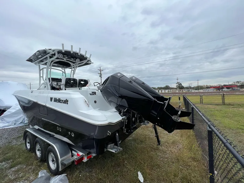 Slide: The Image of 2023 Wellcraft 262 Fisherman boat on trailer, parked outdoors under cloudy sky. - 6