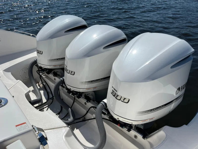 Slide: The Image of Triple Yamaha outboard engines on a 2018 Pursuit DC 365 Dual Console boat. - 10