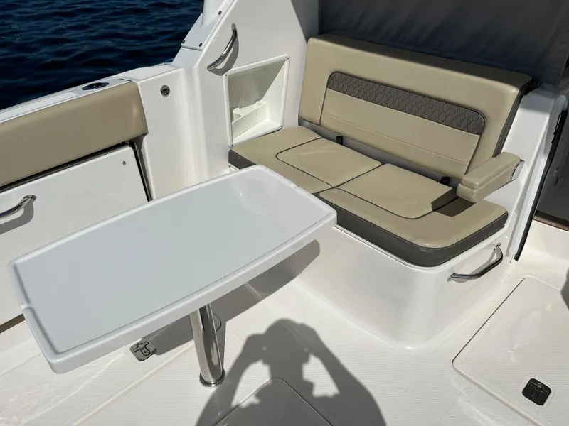 Slide: The Image of 2018 Pursuit DC 365 Dual Console boat interior with seating and table. - 14