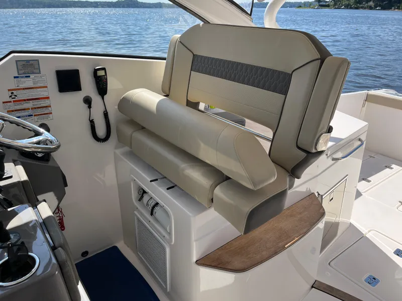 Slide: The Image of 2018 Pursuit DC 365 Dual Console boat interior with helm seat and controls. - 21