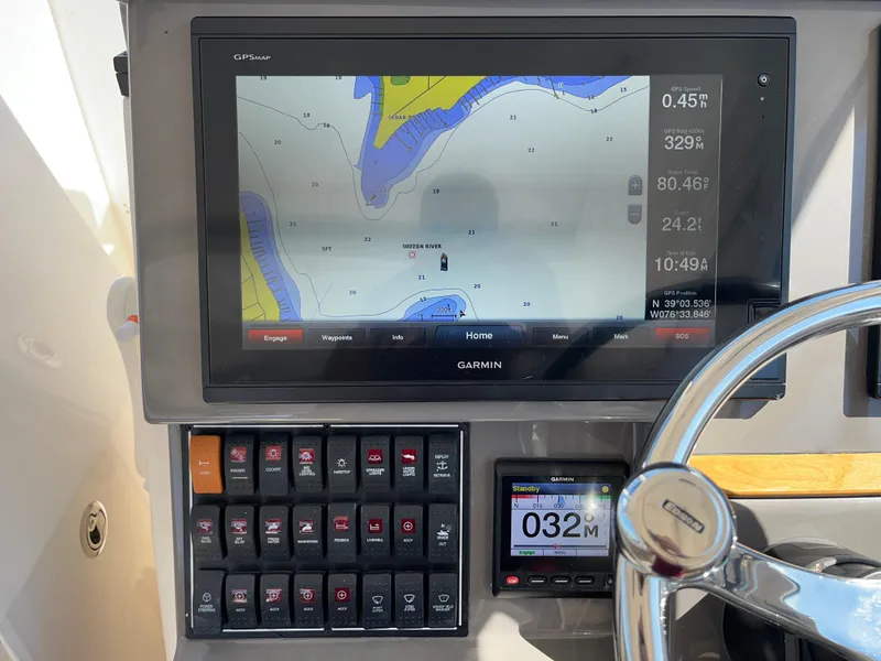 Slide: The Image of Garmin GPS display on 2018 Pursuit DC 365 Dual Console boat dashboard. - 24