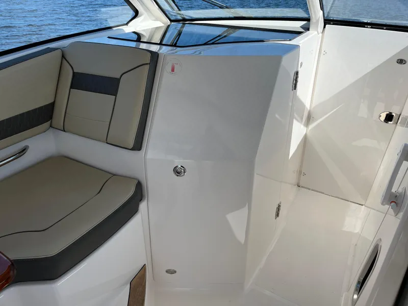 Slide: The Image of 2018 Pursuit DC 365 Dual Console interior with cushioned seating and sleek design. - 28