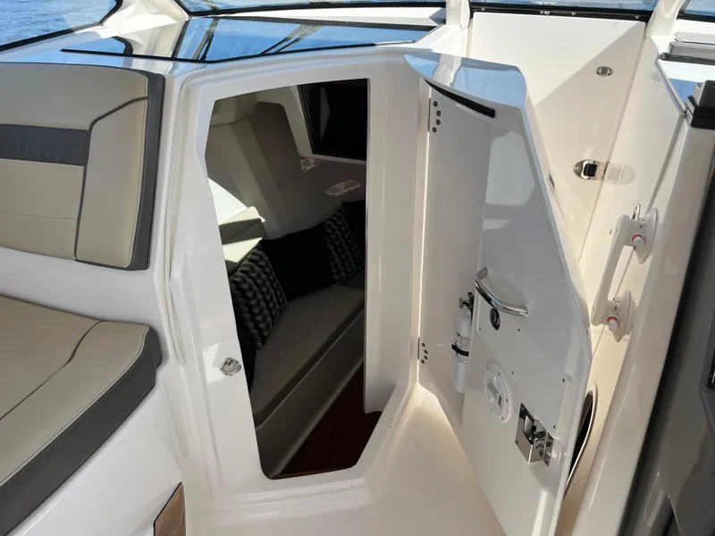 Slide: The Image of 2018 Pursuit DC 365 Dual Console interior cabin with seating and cushions. - 29