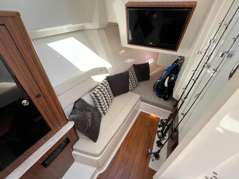 Slide: The Image of Luxurious interior of 2018 Pursuit DC 365 Dual Console with seating and fishing gear. - 30