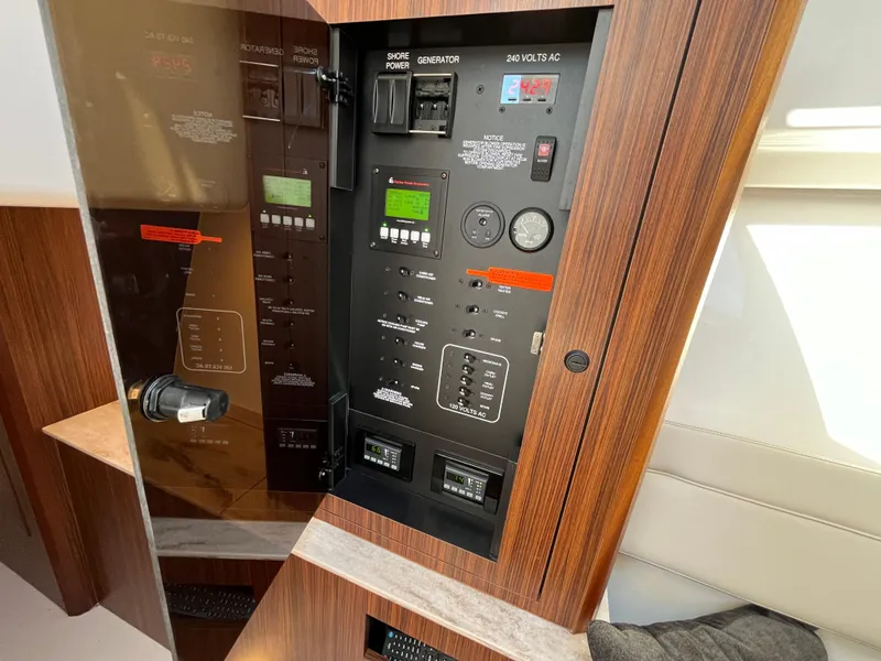 Slide: The Image of Control panel of 2018 Pursuit DC 365 Dual Console boat, featuring various switches and gauges. - 34