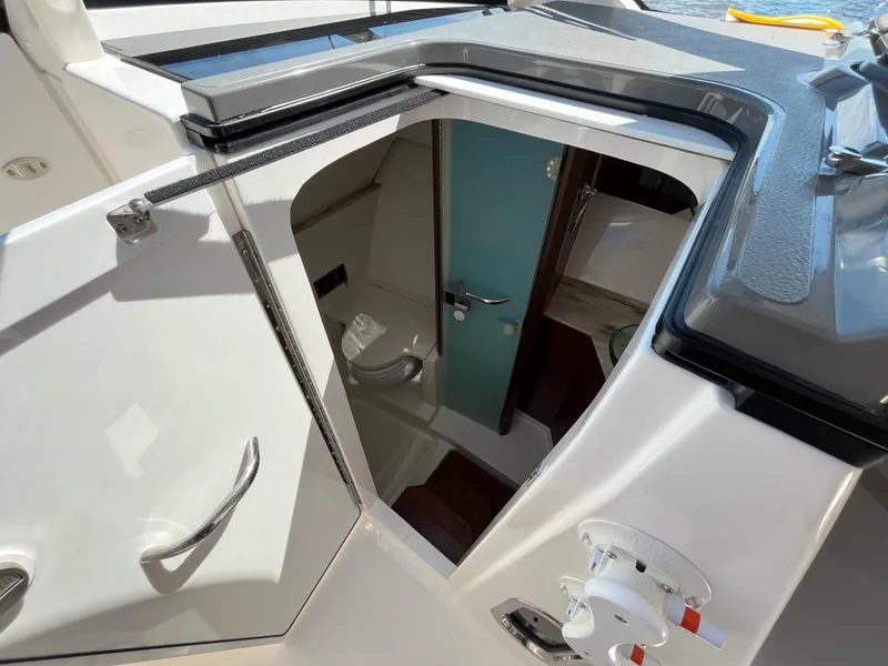 Slide: The Image of Interior view of 2018 Pursuit DC 365 Dual Console boat cabin entrance. - 37