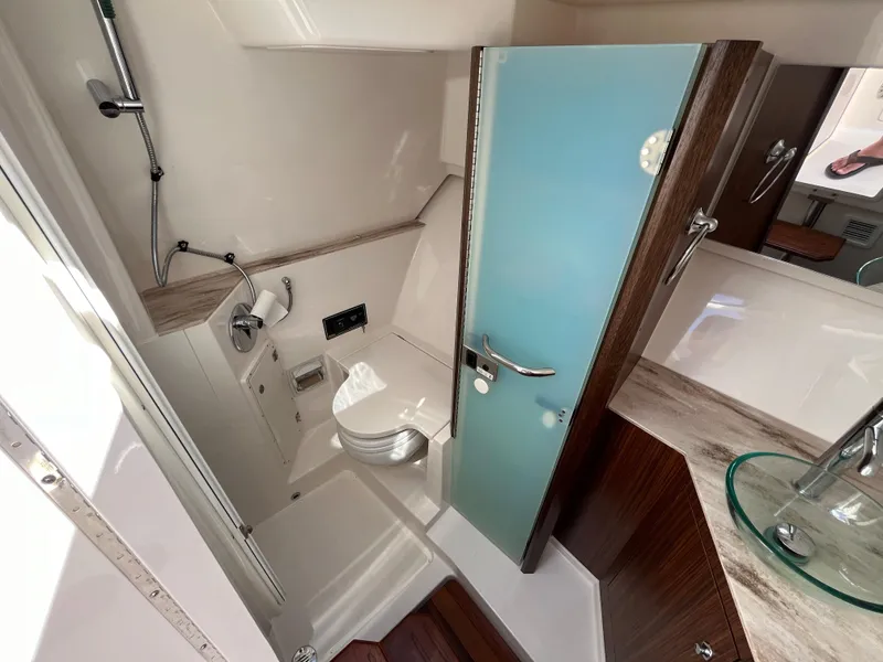 Slide: The Image of Interior of 2018 Pursuit DC 365 Dual Console boat bathroom with modern fixtures. - 39
