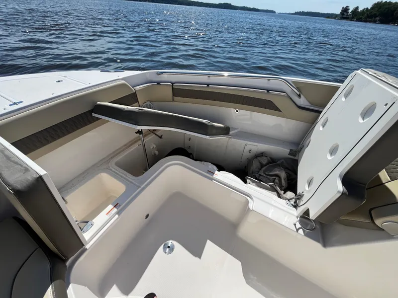 Slide: The Image of 2018 Pursuit DC 365 Dual Console boat interior with seating, on a sunny day at sea. - 44