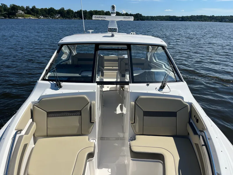 Slide: The Image of 2018 Pursuit DC 365 Dual Console boat on a calm lake. - 47