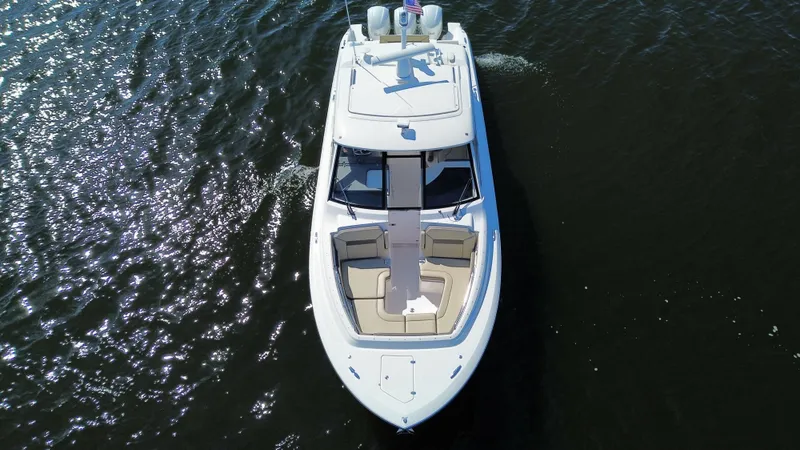 Slide: The Image of 2018 Pursuit DC 365 Dual Console boat on water, aerial view. - 7