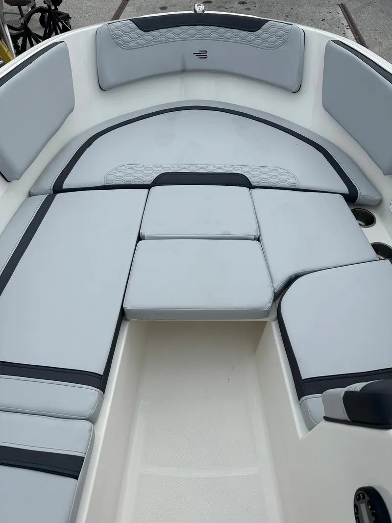 Slide: The Image of 2025 Bayliner M15 boat interior with cushioned seating and modern design. - 2