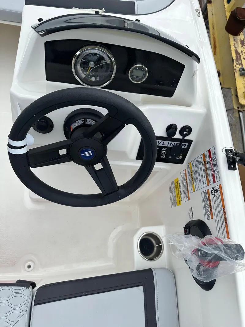 Slide: The Image of 2025 Bayliner M15 boat dashboard with steering wheel and control panel. - 4
