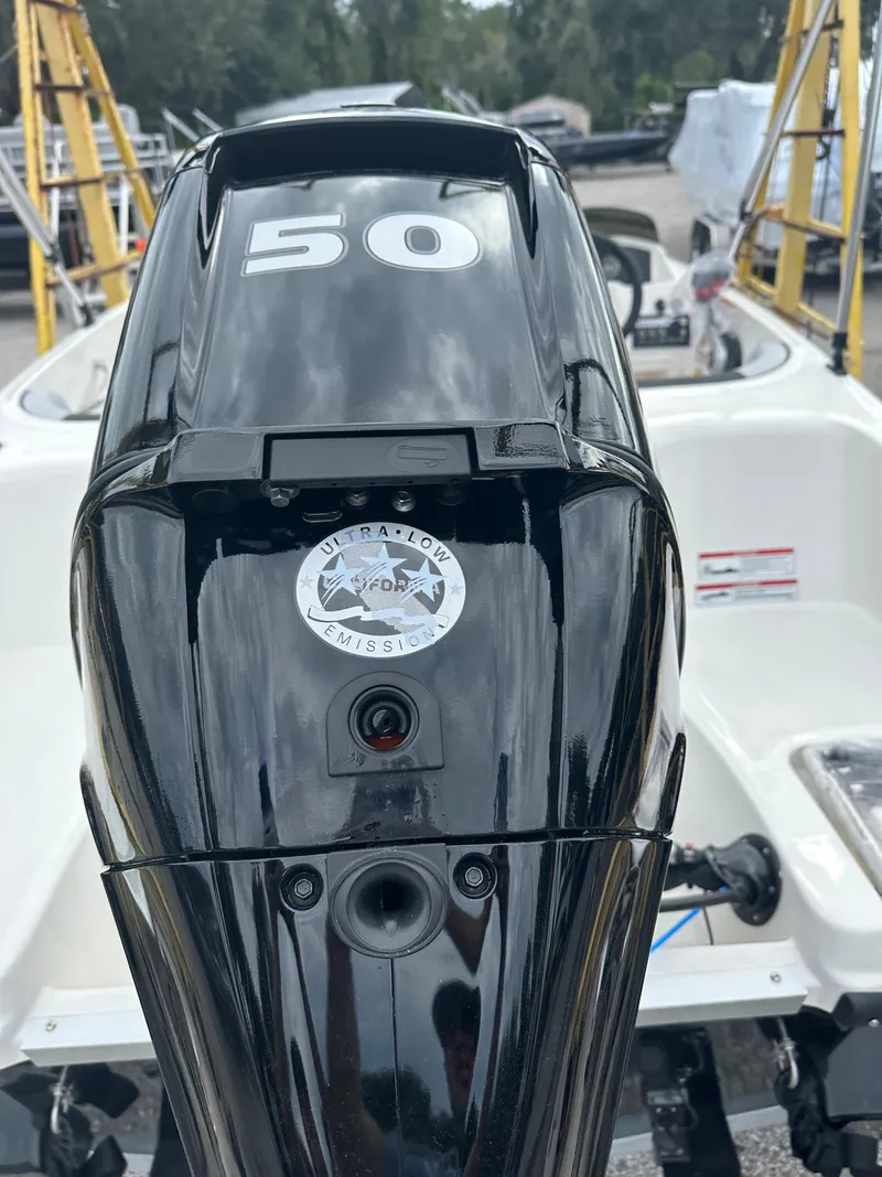 Slide: The Image of 2025 Bayliner M15 boat with a 50 HP outboard motor, rear view. - 7