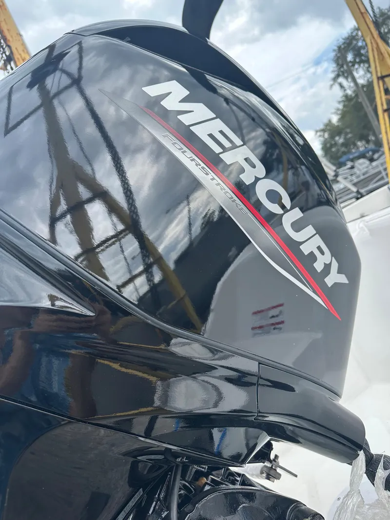 Slide: The Image of 2025 Bayliner M15 with Mercury outboard engine, docked under cloudy sky. - 8