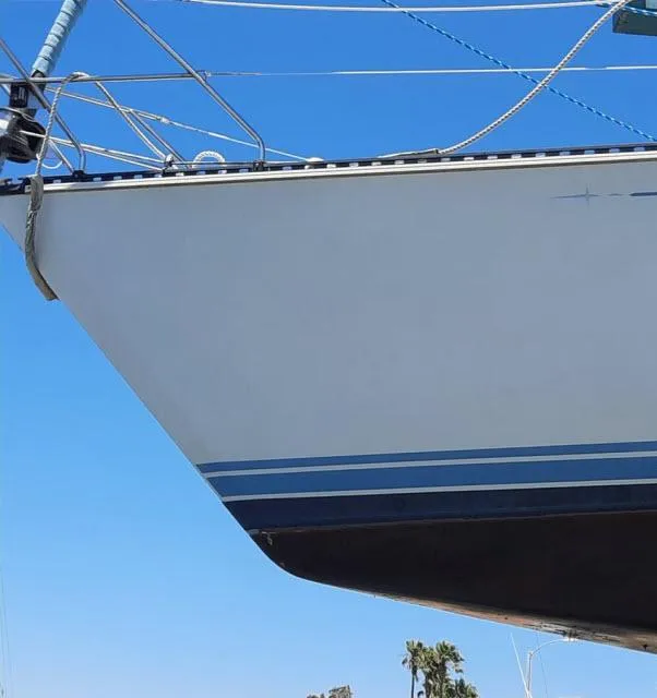 Slide: The Image of 1987 C&C 38 MKIII sailboat bow against clear blue sky. - 25