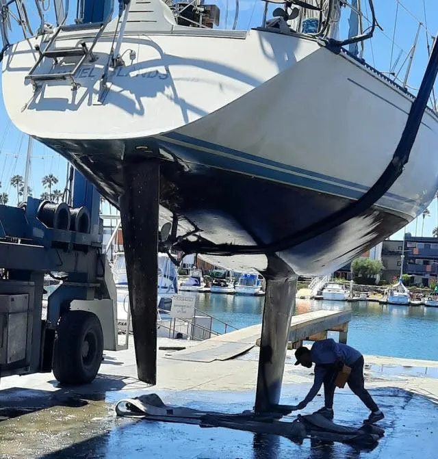Slide: The Image of 1987 C&C 38 MKIII sailboat undergoing maintenance at a marina. - 27