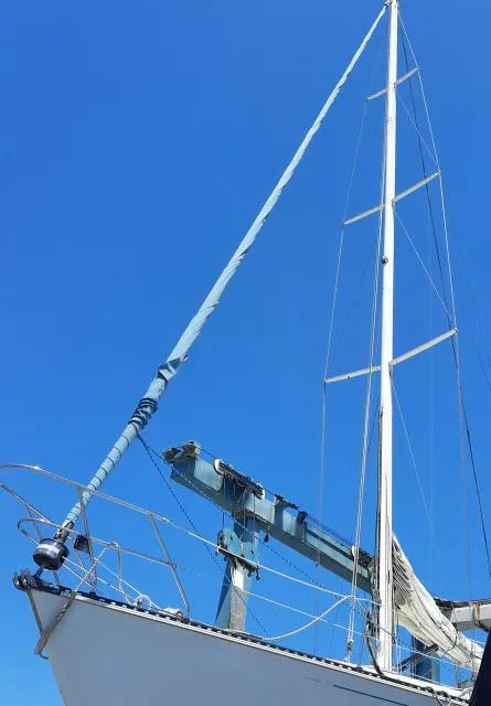 Slide: The Image of 1987 C&C 38 MKIII sailboat with tall mast against clear blue sky. - 28