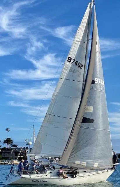 Slide: The Image of 1987 C&C 38 MKIII sailboat on water under clear blue sky. - 31