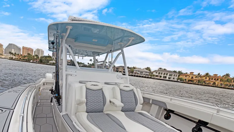 Slide: The Image of 2021 Invincible 42 Center Console Cabin boat on a scenic waterfront. - 12