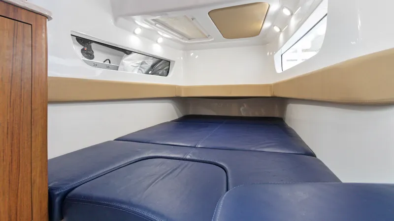 Slide: The Image of 2021 Invincible 42 Center Console Cabin interior with blue and beige seating. - 31