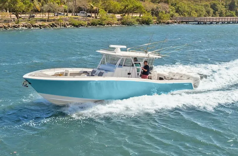 Slide: The Image of 2021 Invincible 42 Center Console Cabin cruising on blue water. - 4