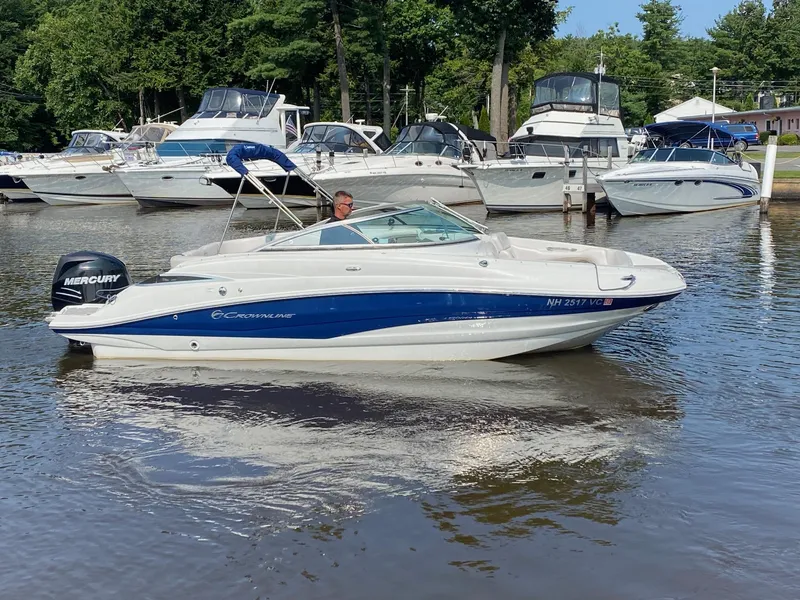 Slide: The Image of 2015 Crownline Eclipse E2 boat on a calm marina with other boats. - 0